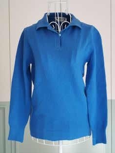 A classic women's collared sweater from the 1970's. A cable knit pattern vintage sweater in blue color with a collared neckline. Jumper has long sleeves and a banded waist. Would look great with high waist jeans. Material is very high quality lambswool. Made in Italy Material: 100% Pure virgin wool Size: Not marked. Fits XS/S. To be sure this item would fit you, please look at the measurements below. Approximate Measurements: (taken while garment is lying flat, double armpit to armpit): Shoulder Blue Collared Polo Sweater, Blue Fitted Collared Polo Sweater, Blue Collared Winter Sweater, Classic Blue Collared Sweater, Classic Blue Polo Sweater For Fall, Classic Fitted Blue Polo Sweater, Fitted Blue Classic Polo Sweater, Fitted Classic Blue Polo Sweater, Blue Collared Polo Sweater For Fall