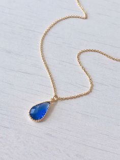 Blue Quartz Teardrop Necklace, Royal Blue Necklace, Small Sapphire Pendant, Dainty Minimal Gold Necklace, Gift for her, September Birthstone This simple dainty necklace features an deep royal blue quartz teardrop set in texturized bezel in your choice of gold filled or sterling silver. This framed stone pendant is suspended from a delicate cable chain in the finish of your choice. This necklace is simply perfect for everyday wear and is perfect for layering with other pieces in your collection. Elegant Blue Crystal Necklaces With Adjustable Chain, Elegant Blue Crystal Necklace With Adjustable Chain, Elegant Blue Crystal Necklace With Clavicle Chain, Elegant Blue Teardrop Drop Necklace, Blue Teardrop Pendant Necklace With Adjustable Chain, Blue Teardrop Necklace With Adjustable Chain, Blue Teardrop Crystal Necklace For Gifts, Dainty Blue Teardrop Pendant Necklace, Blue Gemstone Teardrop Pendant Necklace