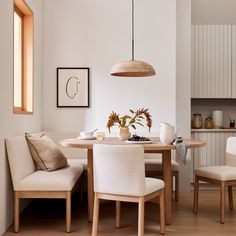 a dining room table with chairs and a bench