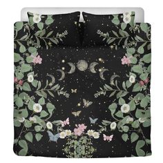 an image of a black bed with flowers and butterflies on the pillow cover that is in front of it