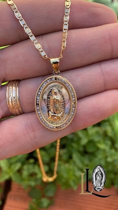 Embrace your faith with grace and style through our Virgen de Guadalupe Necklace. Ideal for women, it makes a stunning accessory for daily wear or special occasions, offering a meaningful way to keep the Virgen de Guadalupe close to your heart. PRODUCT DETAILS * Material: 14K Gold Filled * Metal Purity: 14K * Chain Size: 20" Inches * Chain Thickness: 2.8mm * Pendant Size: 28x20mm * Stone Type: Cubic Zirconia * Stone Shape: Round * Chain Style: Valentino Link * Gender: Female * Clasp Type: Lobste Yellow Gold Oval Necklace With Our Lady Of Guadalupe, Gold Medallion Necklace With Our Lady Of Guadalupe, Spiritual Oval Necklace Featuring Our Lady Of Guadalupe, Gold Medallion Necklace Of Our Lady Of Guadalupe, Gold Our Lady Of Guadalupe Necklace In 14k Gold, Spiritual Oval Our Lady Of Guadalupe Necklace, Gold Our Lady Of Guadalupe Pendant Necklace, Medallion Necklace, Ring Bracelet