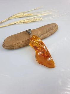 Natural raw Baltic Amber [endant. Natural shape as found. Comes with a black string. Handmade true gemstone necklace. Made by me with passion and love. Not pressed but natural Baltic Amber. Cobochon size: 8 x 2,5 cm. With natural imperfections. As found. This item was made of natural Baltic Amber. All the amber used in my jewelry is collected in my home country Lithuania. I sell only genuine, real, not pressed, authentic, natural Baltic Amber. Item may have natural imperfections. Gift Natural Stones Baltic Amber Necklaces, Handmade Baltic Amber Spiritual Necklace, Handmade Baltic Amber Necklace In Spiritual Style, Baltic Amber Necklace With Natural Stones For Gift, Spiritual Handmade Baltic Amber Necklaces, Amber Gemstone Jewelry As Gift, Amber Gemstone Jewelry For Gifts, Gift Necklace With Baltic Amber And Natural Stones, Gift Necklaces With Baltic Amber And Natural Stones