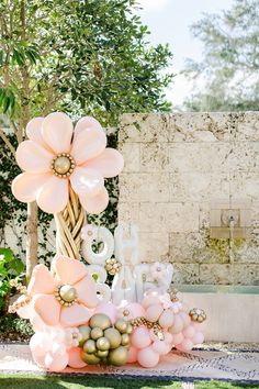 balloons and flowers are arranged in the shape of letters