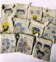 nine small bags with flowers painted on them