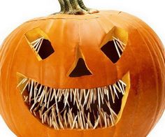 an orange pumpkin with spikes on it's face and mouth is shown in front of a white background