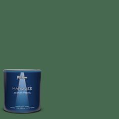 a can of behr marquee paint on a green background