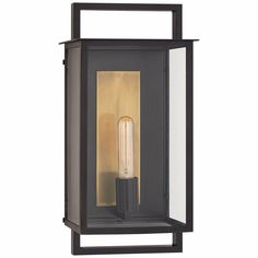 an outdoor wall light with a black frame