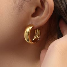 These chunky Bianca Gold Hoop Earrings offer a bold yet stylish statement jewelry look. Crafted from stainless steel and 18k gold-plated for a luxurious finish, each hoop is designed to last, making it an ideal addition to any wardrobe. DETAILS & SIZE Finish: 18k gold plate Material: Stainless Steel Measurements: Diameter; 28mm; Width: 11mm Comes with friction earring backs Waterproof, tarnish-resistant, and nickel free Shop Earrings for more options! Angel Purple, Jewelry Classy, Minimalist Rose, Diamond Engagement Band, Chunky Gold Hoop Earrings, Pink Triangle, Butterfly Bow, Platinum Rose Gold, Boho Crystal