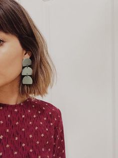 a close up of a person wearing earrings