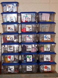 a stack of plastic containers filled with letters and numbers