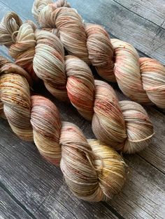 several skeins of yarn sitting on top of a wooden table