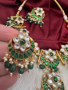 Jadau Kundan Green Floral Necklace with matching EarringsColor : GoldenSize : Necklae Length : 16 Inches; Earrings Length : 1.5 InchesStones : Jadau Kundan Pearls Traditional Round Kundan Necklace With Stones, Green Hand Set Round Chandbalis, Green Hand Set Temple Jewelry Tikka, Hand Set Green Temple Jewelry Tikka, Traditional Festival Earrings With Stones, Traditional Round Bridal Necklace With Stones, Festive Kundan Necklace With Matching Earrings, Temple Jewelry Kundan Necklace With Matching Earrings, Kundan Necklace With Matching Earrings For Festivals