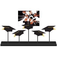 four graduation hats are placed on top of each other in front of a white background