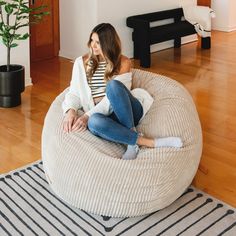 a woman sitting on top of a bean bag chair