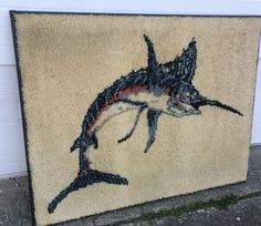 a door mat with a painting of a marlin fish on it's side