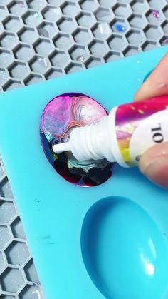 someone is painting the inside of an egg shell with acrylic paint on it