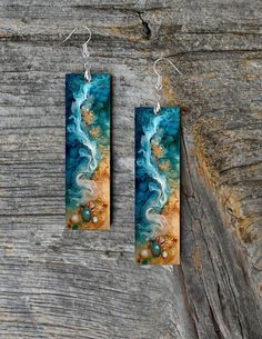 the earrings are made out of wood and painted with acrylic paint