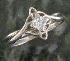 a white gold ring with a princess cut diamond