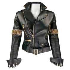 FAUSTO PUGLISI Black leather biker jacket with large golden studs and crystals 100% Leather 100% Silk lining 100% Polyurethane padding Size IT40 Made in Italy Flat measures: Length cm. 53 Shoulders cm. 39 Bust cm. 41 Waist cm. 37 Sleeve cm. 62 Excellent condition Biker Clothes, Cute Leather Jackets, Masculine Fashion, Black Leather Biker Jacket, Fausto Puglisi, Biker Outfit, Azzedine Alaia, Studded Jacket, Concept Clothing