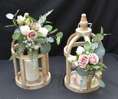 two vases with flowers and greenery in them