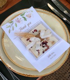 a plate with some food on it and a thank you card sitting on top of it