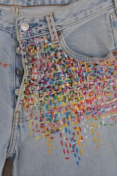 a pair of jeans with colorful sequins on them