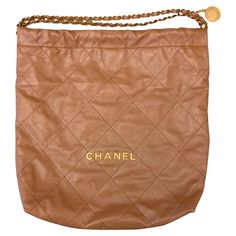 New pre-owned Chanel 22 bag crafted in a light and supple shinny quilted calfskin leather. It features a metal chain interlaced with leather and a "CHANEL Paris” medallion with an openwork double C. A snap and drawstring closure as well as a roomy interior with an inside zipped pocket and a removable pouch. Quite a trendy bag !!! Year: 2022 Material: Calfskin Leather Lining: Chèvre Mysore - Goat skin leather Color: Camel Measurements: 47cms x 46cms x 10cms - approx. 18.5" x 18.1" x 3.9" Conditio Chanel 22 Bag, Chanel 22, French Houses, Shoulder Bag Brown, Leather Artisan, Chanel Paris, Mysore, The Expert, Metal Chain