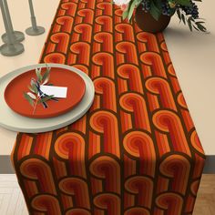 the table is set with an orange and red pattern