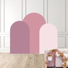 a pink and white color scheme with some items on the floor in front of it