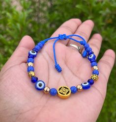 Adjustable to wrist Adjustable Blue Symbolic Bracelet, Gold Evil Eye Bracelet With Letter And Round Beads, Casual Evil Eye Friendship Bracelets As Gift, Casual Evil Eye Friendship Bracelets For Gifts, Adjustable Spiritual Braided Bracelet With Evil Eye, Adjustable Braided Evil Eye Bracelet For Spiritual Protection, Adjustable Spiritual Evil Eye Braided Bracelet, Adjustable Evil Eye Spiritual Jewelry, Spiritual Evil Eye Bracelet With 8mm Beads