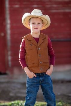 The Youth Bronco Canvas Vest is made from our premium 12 ounce cotton canvas, is durable and strong, just what the upcoming little working rancher and cowboys need. This vest has several unique elements, one being the shoulder western yoke on the front and back of the vest, an open v-neck with lapel and four Wyoming Traders logo buttons. This vest is lined with a polyester satin lining. The Bronco Vest has four front welt pockets, two for your hands and two chest pockets, all lined with a polyes Western Style Brown Vest For Western-themed Events, Brown Western Vest For Western-themed Events, Western Rodeo Vest, Western Style Sleeveless Vest For Rodeo, Canvas Vest, Tractor Supply, The Youth, Kids Outerwear, Polyester Satin