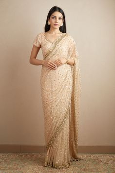 Peach saree with sequin embroidered motifs and scallop border. Paired with embroidered, padded blouse.
Components: 2
Pattern: Embroidered
Type Of Work: Nakshi, Cutdana, Sitara
Neckline: Scoop
Sleeve Type: Sleeveless
Fabric: Net, Crepe
Color: Peach
Other Details: 
Floral pattern
Back tassel tie-up
Occasion: Bride,Wedding - Aza Fashions Anarkali Pre-draped Saree With Sequins For Diwali, Anarkali Style Pre-draped Saree With Sequins For Festive Occasions, Reception Tissue Silk Traditional Wear With Sequins, Wedding Saree With Embroidered Sequins, Elegant Sequined Embroidered Fabric For Navratri, Sequined Anarkali Pre-draped Saree For Diwali, Anarkali Sequined Pre-draped Saree For Diwali, Embellished Chanderi Saree For Reception, Festive Chanderi Pre-draped Saree With Sequins