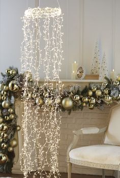 a white chair sitting in front of a fireplace covered in christmas decorations and lights on top of it