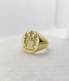 Gold Men Signet Ring - Coat of Arms Ring - Armorial Ring - Family Crest Ring Dimensions: 1.9 x 1.6cm of oval face Band Width: 7mm Your custom signet ring can be made out of 9K Solid Gold, 14K Solid Gold, or 18K Solid Gold. Leave us a message with your desired finish of the band. (Yellow Gold, White Gold, or Rose Gold). ♠ Face can be made in 3D relief or embossed in seal ring type. ♠ We discuss together your ideal jewelry design, in shape, style, and details. ♠ Our customers participate and invol Formal Yellow Gold Coat Of Arms Ring, Ceremonial 14k Gold Signet Ring With Polished Finish, 14k Gold Ceremonial Signet Ring With Polished Finish, Classic Coat Of Arms Ring, Gold Engraved Ring With Coat Of Arms For Anniversary, Formal Signet Ring With Coat Of Arms, Ceremonial Oval Signet Ring Stamped 14k, Gold Jewelry With Coat Of Arms In 14k Gold, Gold Signet Ring With Coat Of Arms