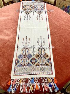 🔺 Visit the vibrant heritage of Crete with this stunning hand-embroidered ethnic table runner, Originating from the 1990s, it embodies the essence of traditional Greek folk arts with its intricate Cretan embroidery and timeless patterns. Recently collected and remodeled, this vintage piece now features handmade colorful bangs on both sides, adding a touch of lively charm and making it a truly presentable ethnic artwork.  Flawless. 43.30 x 13.77 inches / 1.10 x 0.35 meters 🔺 A link to our shop: Embroidery Decor, Ethnic Artwork, Green Soap, Framed Embroidery, Traditional Pattern, Art Populaire, Art Textile, Table Cover, Decor Vintage