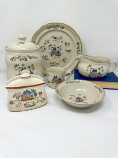 a table topped with dishes and plates covered in china style design on top of each other