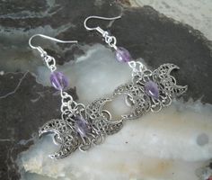 Amethyst Triple Moon EarringsThis beautiful earrings have sterling silver plated triple moon design pendants with amethyst settings and amethyst beads.  1.5" long from hook bottom. Silver Spiritual Moon Phase Earrings, Witchy Dangle Earrings For Festival, Witchy Silver Jewelry Gift, Silver Moon Phase Earrings, Bohemian Silver Crystal Earrings With Moon Charm, Silver Bohemian Crystal Earrings With Moon Charm, Witchy Metal Jewelry With Moon Charm, Mystical Crescent Amethyst Jewelry, Silver Spiritual Crystal Earrings Nickel Free