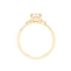 a yellow gold engagement ring with three stones on the band and a square cut diamond in the center