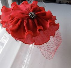 This Red Chiffon Crystal Flower Fascinator Hat with Veil and Satin Headband is a beautiful accessory for weddings, parties, cocktail, and other special occasions. It is elegant, sophisticated, fashionable, and super chic! Will definitely add a glamorous sparkling touch to your outfit!! I only accept PayPal and ship all orders within 24 hours via USPS. Feel free to send me a convo with any questions. Thank you for visiting Hettie Hair Accessories! Elegant Adjustable Fascinator As A Gift, Flower-shaped Party Fascinator With Flower Decoration, Evening Fascinator With Handmade Flowers And Adjustable Fit, Elegant Fascinator With Pinched Crown For Gift, Handmade Flowers Adjustable Fascinator For Evening, Elegant Adjustable Fascinator With Matching Headband, Elegant Pinched Crown Fascinator Gift, Handmade Flowers Headband For Formal Occasions, Elegant Kentucky Derby Fascinator With Matching Headband