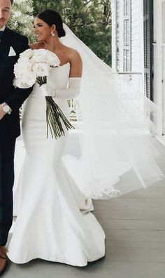 a bride and groom standing on the porch