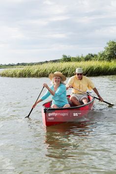 a man and woman in a canoe on the water