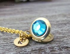 "Blue Zircon December Birthstone Swarovski Locket Necklace, Personalized Hand Stamped Initial Swarovski Blue Zircon Tiny Gold Locket Necklace This listing is for one initial locket necklace. -The round hand stamped disc is 5/16\" round; brass -The locket is 1/2\" round; brass -The chain is 18\" long; stainless steel gold plated finished with lobster claw clasp -The Swarovski crystal is 8,5mm PLEASE.... select initial of your choice from the drop down menu This necklace will be shipped in a gift Turquoise Crystal Jewelry Gift, Turquoise Crystal Jewelry For Gifts, Turquoise Locket For Wedding Jewelry, Turquoise Locket Jewelry For Wedding, Turquoise Wedding Locket Jewelry, Blue Locket Jewelry For Anniversary, Blue Personalized Round Pendant Jewelry, Personalized Blue Round Pendant Jewelry, Blue Locket Jewelry For Wedding