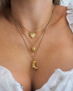 This vintage-inspired strawberry charm necklace is the perfect accessory for a fun, feminine look. Wear the delicate piece alone or layer with your favorite necklaces. 14k gold plated + palladium plating with brass base Chain measures 17" + 2" extender Spring clasp Charm measures approx 10mm by 8.5mm Protective coating, water resistant Heirloom Heart Pendant Necklace With Charms, Vintage Charm Pendant Chain Necklace, Dainty Heart Pendant Jewelry With Vintage Charm, Delicate 14k Gold Filled Tarnish Resistant Charm Necklaces, Elegant Gold-tone Charm Necklace With Vintage Charm, Delicate Yellow Gold Brass Charm Necklaces, Delicate 14k Gold-filled Tarnish-resistant Charm Necklaces, Vintage Jewelry With Delicate Chain For Everyday, Elegant Everyday Necklaces With Vintage Charm