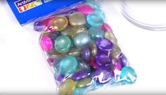 a bag filled with lots of different colored balls