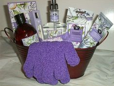 a bucket filled with lots of purple items and cleaning supplies on top of a table