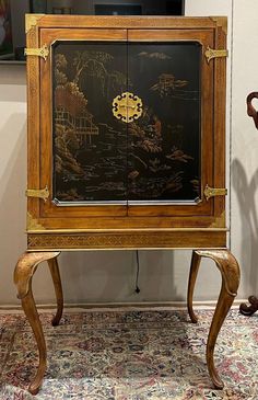 "Exception bar cabinet chest featuring an antique ebony finish with Asian design. Brass accents to the corners and hardware. Mirrored interior back wall with 2 glass shelves. Measures approx 61\" t x 36\" w x 27\" d. Very good condition sitting on Queen Anne style legs, nice patina. If you need more info please call 954 257 2214" Queen Anne Style, Cocktail Cabinet, China Cabinets, Asian Design, Drinks Cabinet, Mirror Interior, Palm Beach Fl, Brass Accents, Bar Cabinet