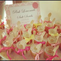 pink lemonade salt scrubs bridal shower favors on a white table with pink ribbon