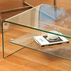 a glass coffee table with a book on top