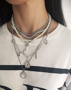 "Explore our stunning necklace collection featuring multi-layered chains with statement pearls, and modern shell pendants - the epitome of timeless elegance and contemporary style. Welcome! 📌Please Kindly Note: It is a set of five layering chain necklaces that have their own clasp, and you can buy them together or separately. 📌The first and second layers are made of stainless steel and zircon stones. 📌The third layer is made of individual glass pearl beads. The clasp is made of zamak, immerse Layered Silver Necklaces Grunge, Pearl Necklace Styling, Pearl Necklace Layering, Layering Chains, Dope Jewelry Accessories, Necklaces Pearl, Pearl Statement Necklace, Silver Necklace Set, Layered Necklaces Silver