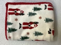 a white and red blanket with santa clause on it